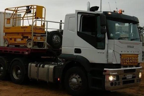 A White Truck With A Yellow Scissor Lift On The Back Of It — Gympie/Childers Towing Pty Ltd in Sunshine Coast, QLD