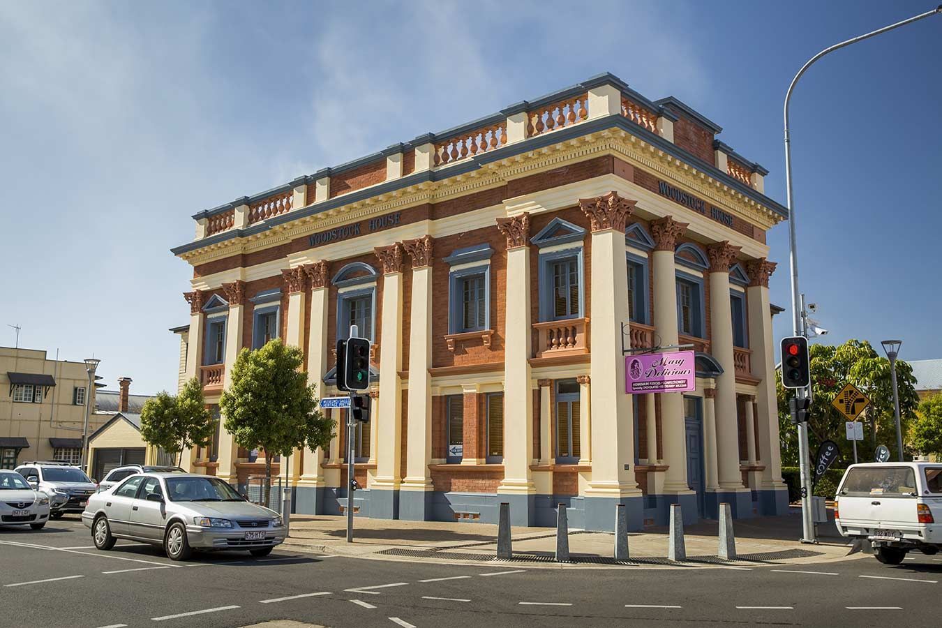 A Large Building With Cars Parked In Front Of It — Gympie/Childers Towing Pty Ltd in Maryborough, QLD