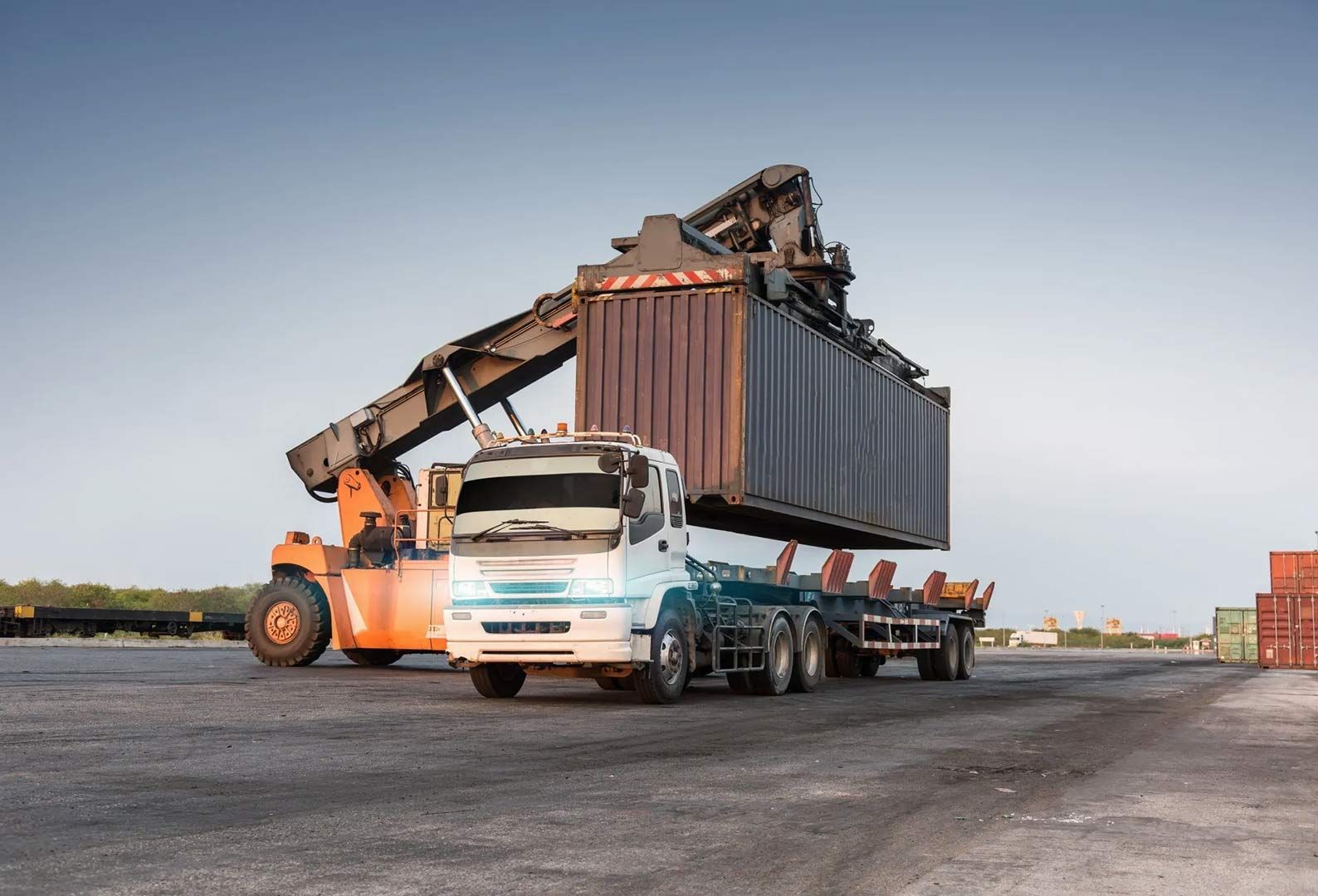 A Truck Is Being Loaded With A Container In A Warehouse — Gympie/Childers Towing Pty Ltd in Sunshine Coast, QLD