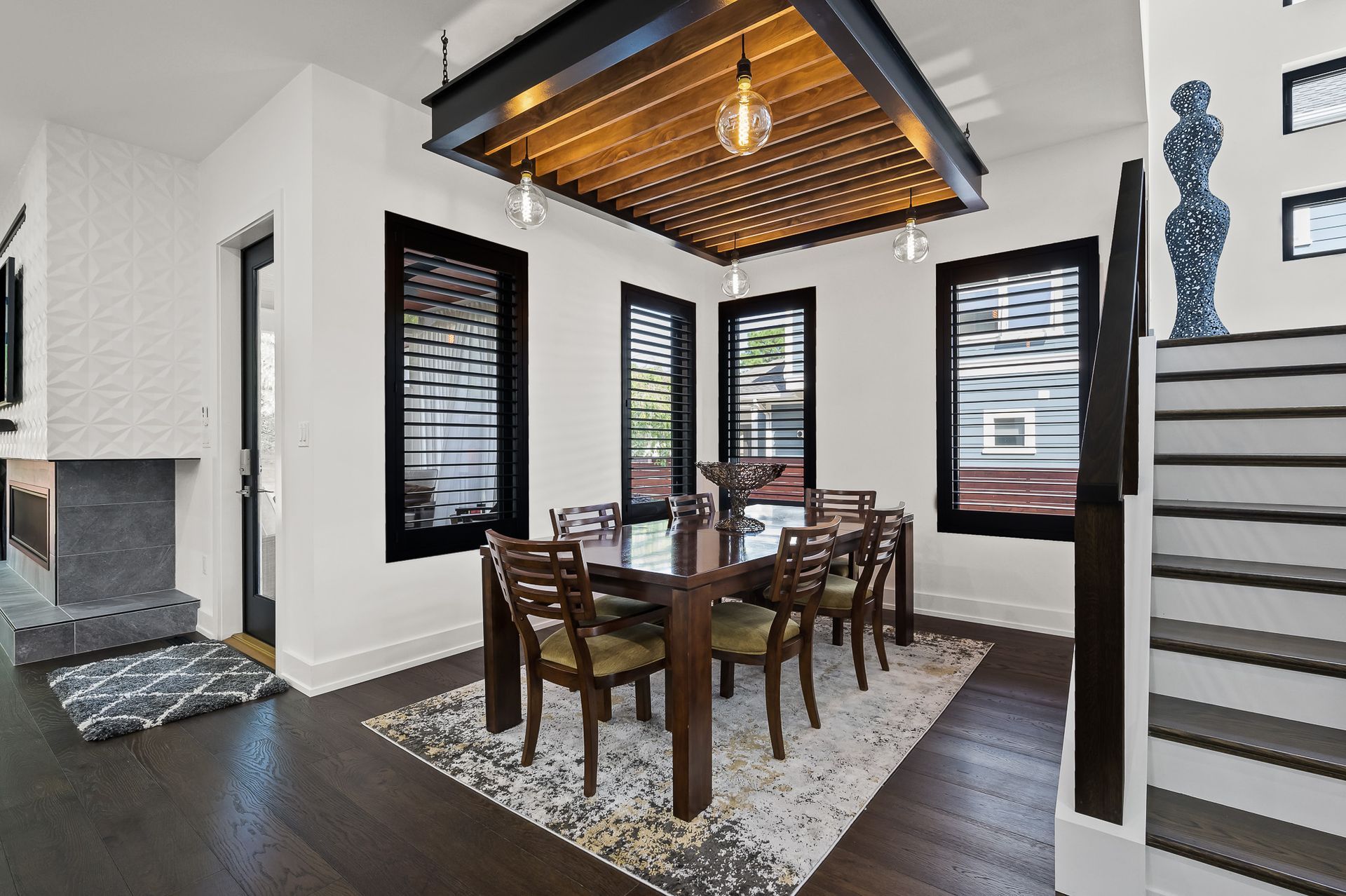 Dining room with dark wood furniture, white walls, and decorative ceiling.