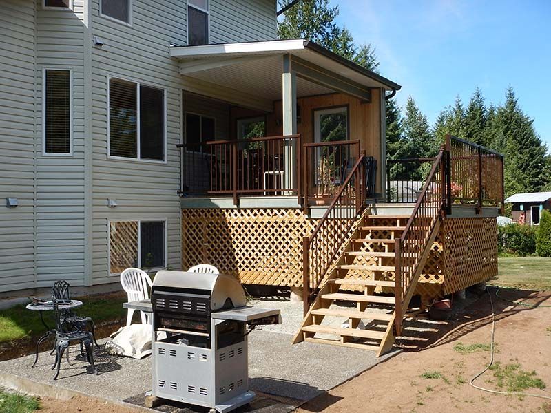 A large house with a large deck and stairs