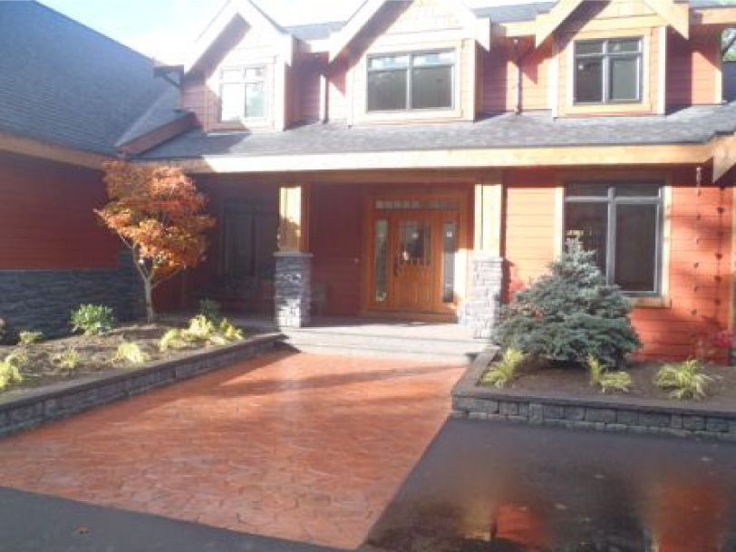 A large house with a driveway leading to it