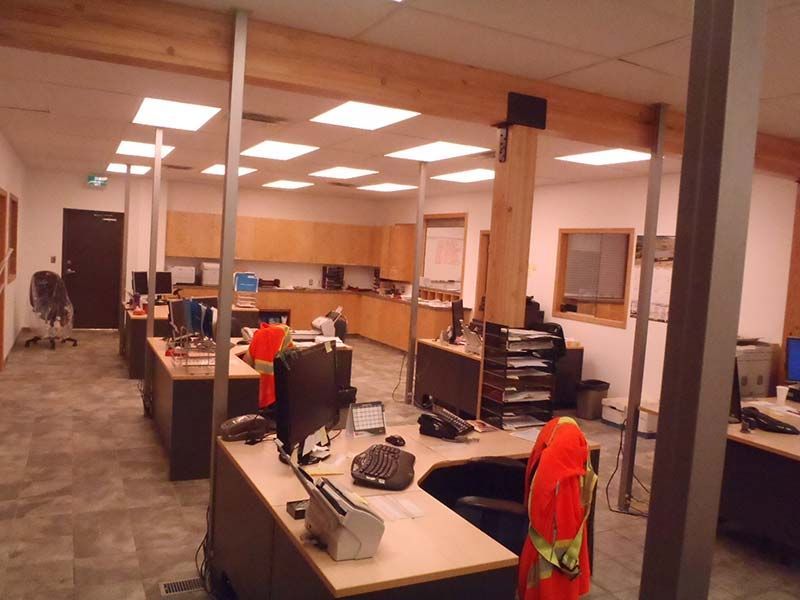 A large office with lots of desks and computers