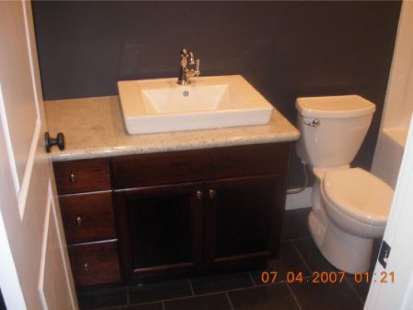 A bathroom with a toilet and a sink taken on january 21 2007