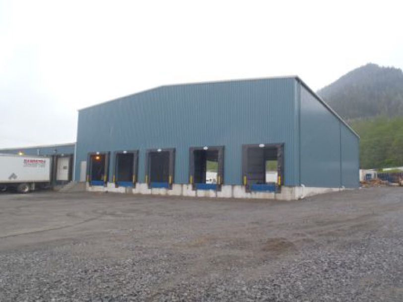 A large blue building with a truck parked in front of it