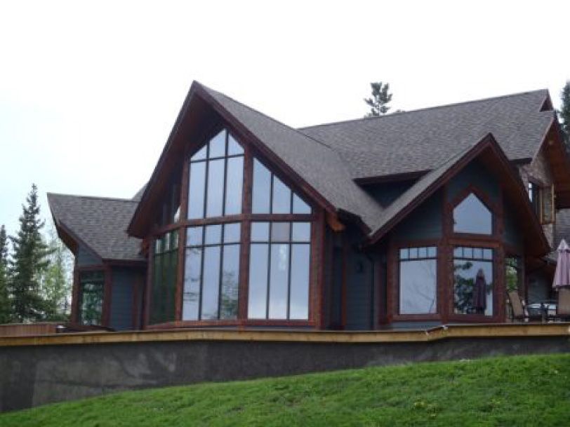 A large house with a lot of windows and a gray roof