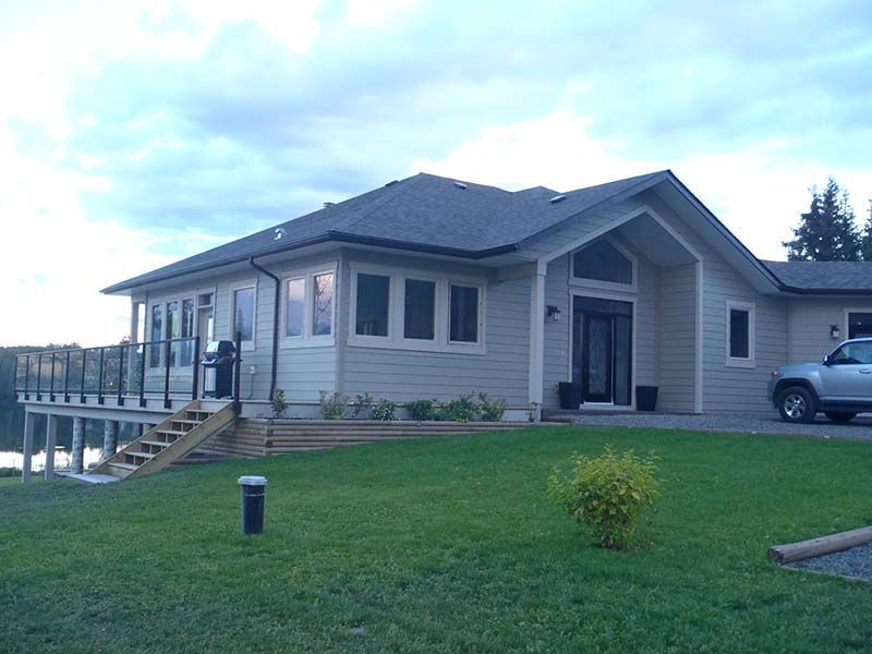 A house with a car parked in front of it