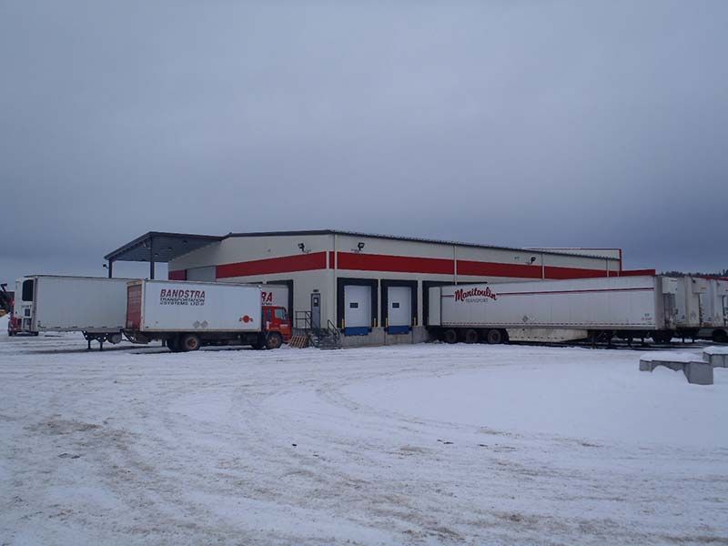 A building with a lot of trucks parked in front of it