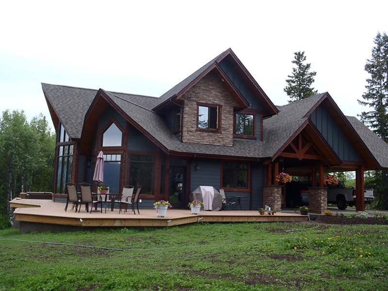 A large house with a large deck in front of it