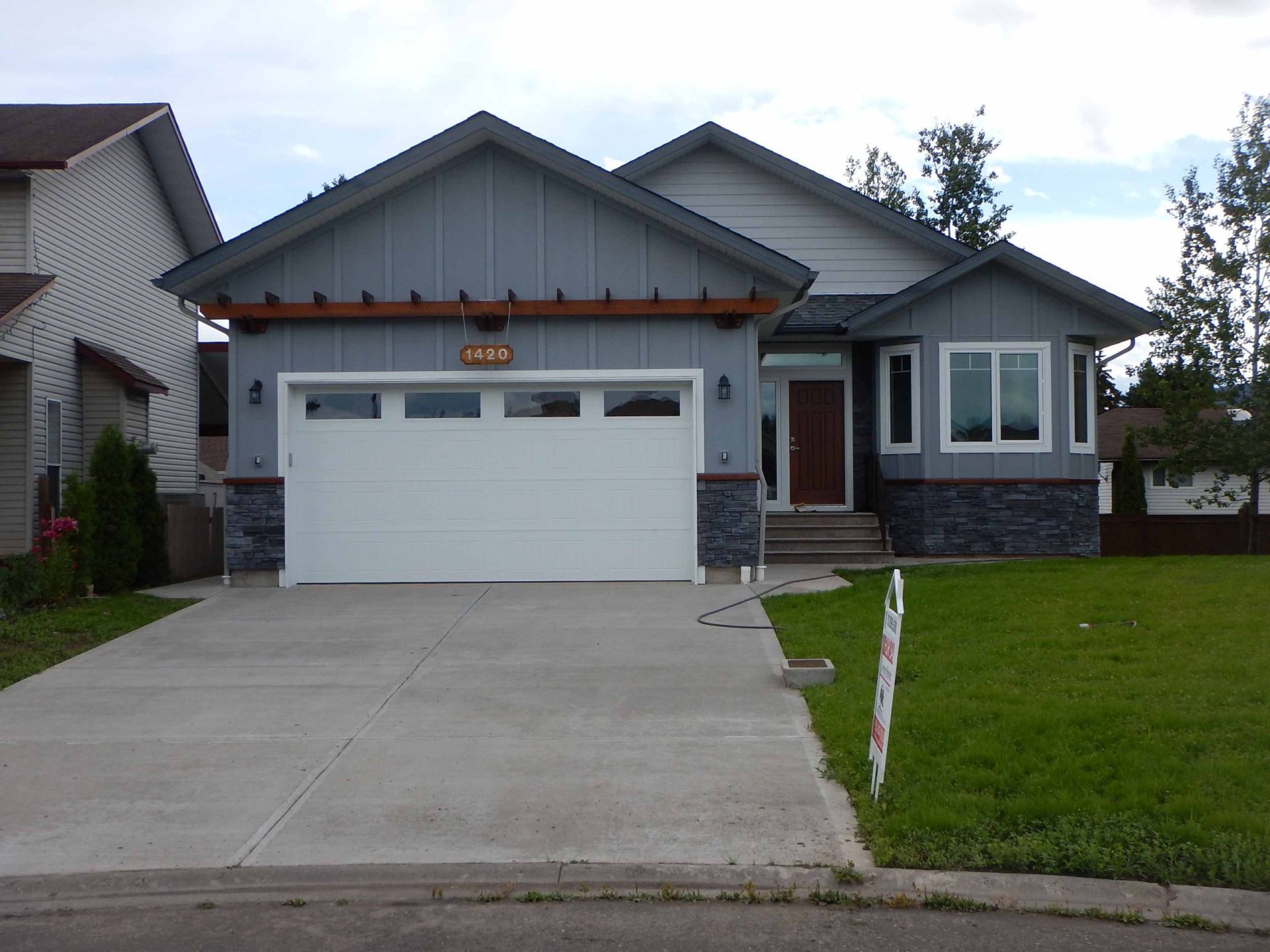 A gray house with a white garage door