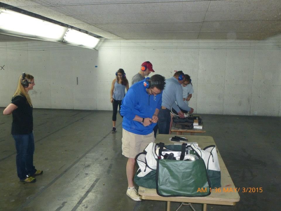 A man is teaching a woman how to box in a gym.