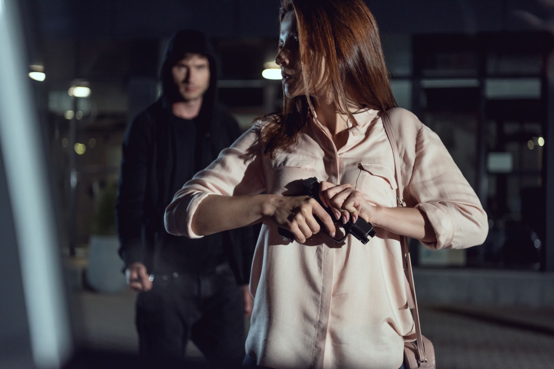 a woman ready to protect herself from an attacker with a gun.