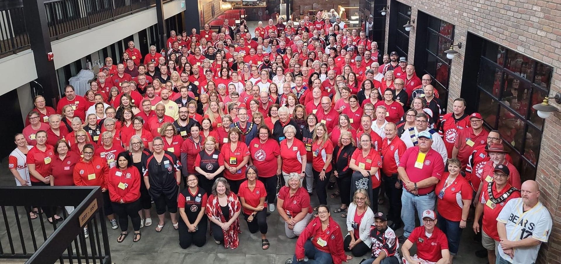 A large group of Kin volunteers pose for an overhead picture.