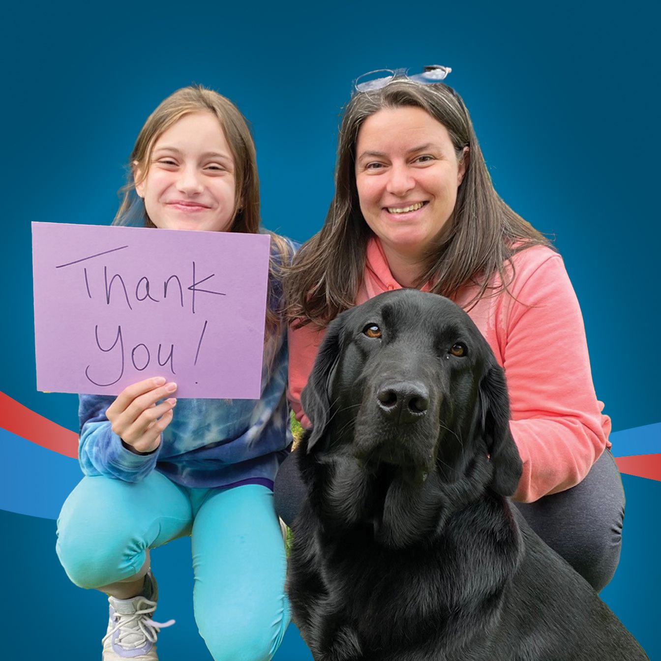 A mom and daughter pose with their black lab and hold a sign that says, thank you.