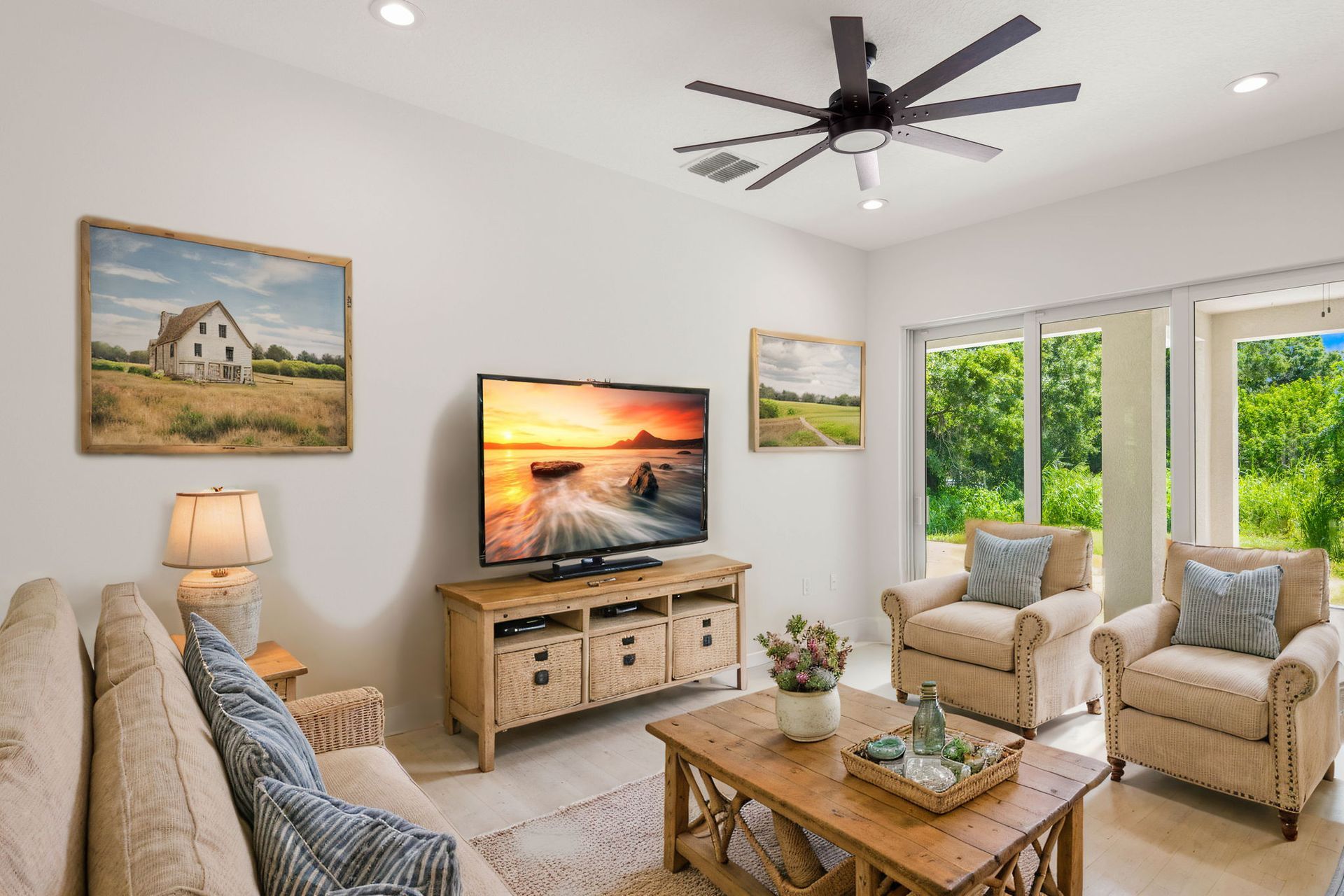 Bright, modern bathroom with glass shower, double vanity, and large windows. White and gold accents.