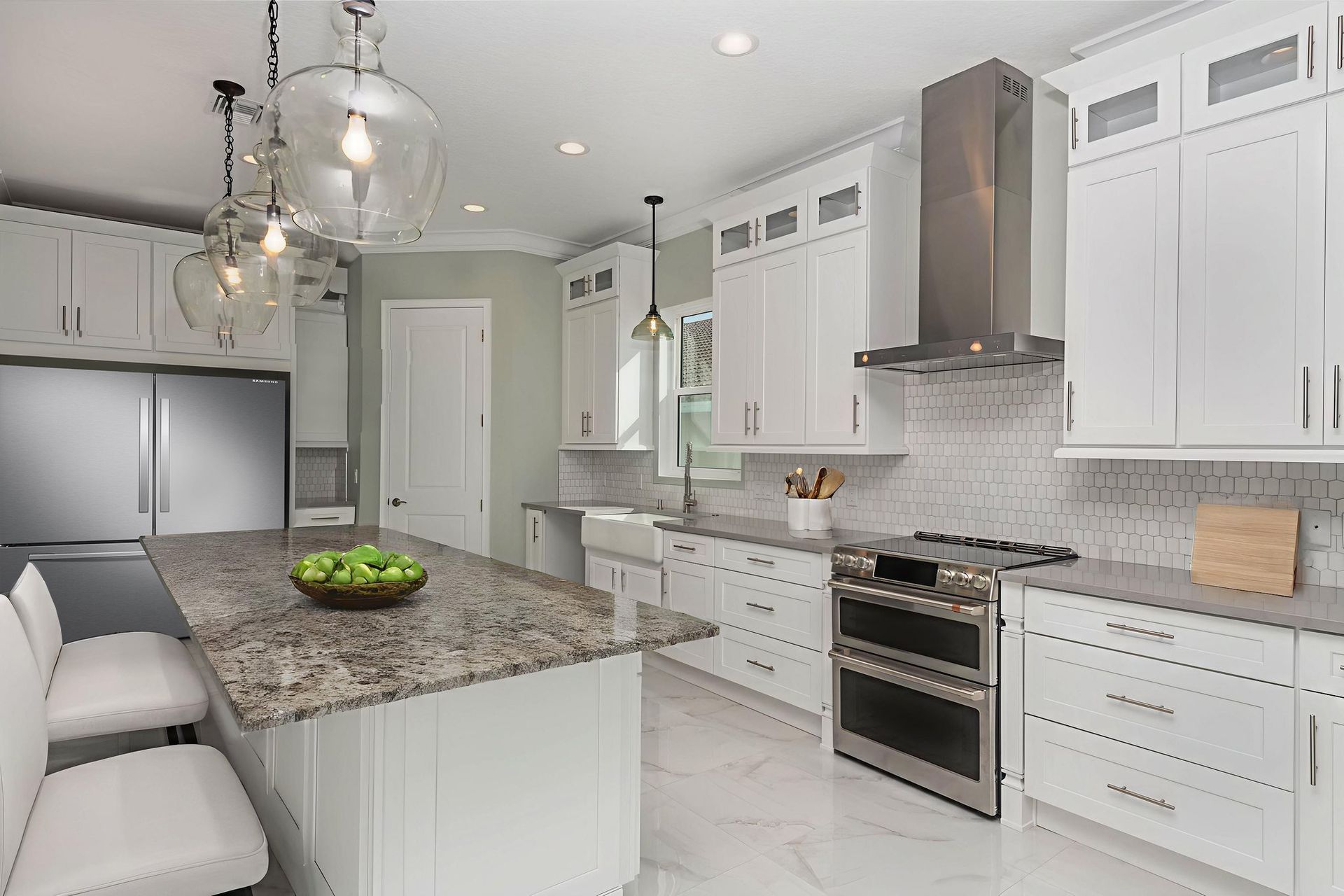 Modern, open-concept living space with gray sectional sofa, wooden coffee table, and kitchen in the background.