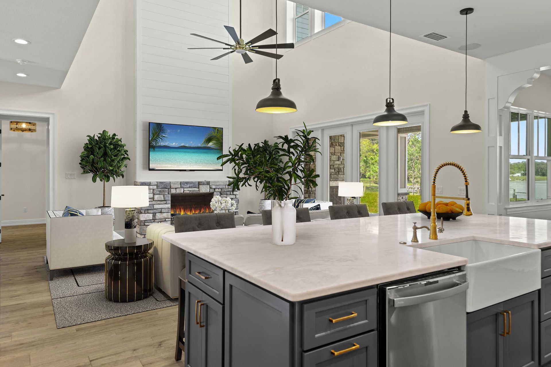 Open-concept living space with kitchen island, living room with fireplace, and large windows.