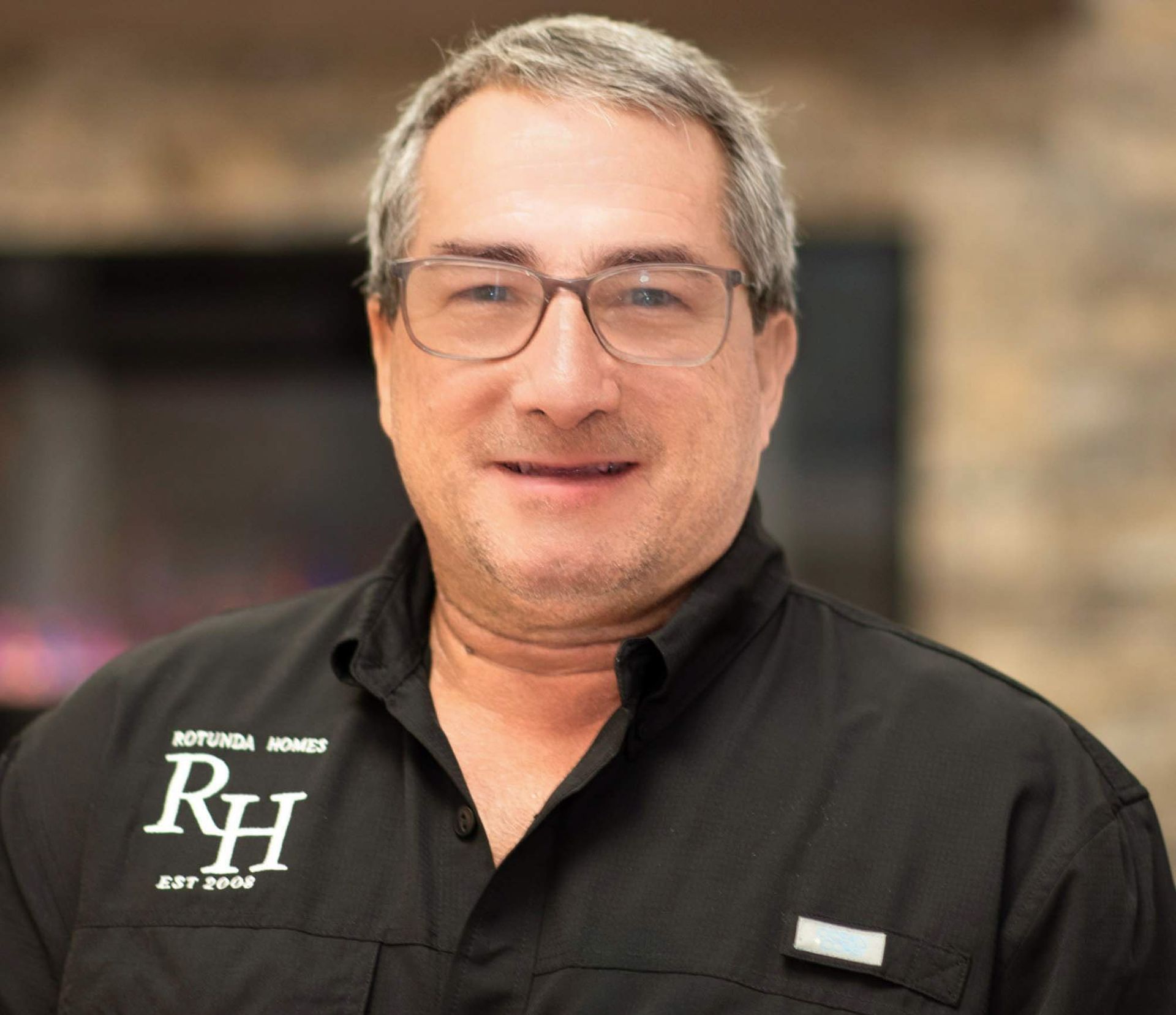 Man wearing glasses and a black shirt with