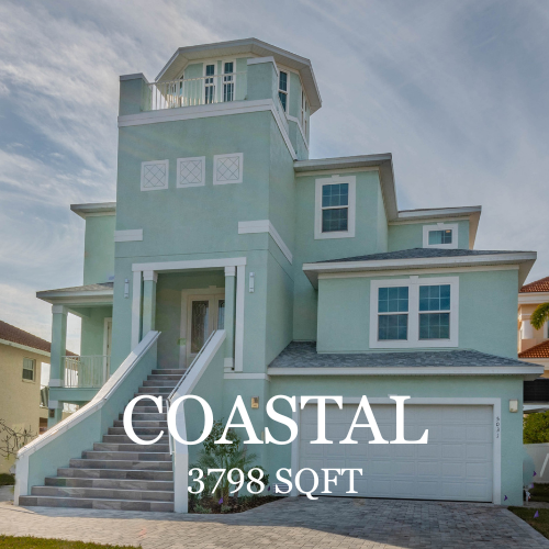 A three-story, light green coastal home with a prominent tower, elevated entryway stairs, and a garage.