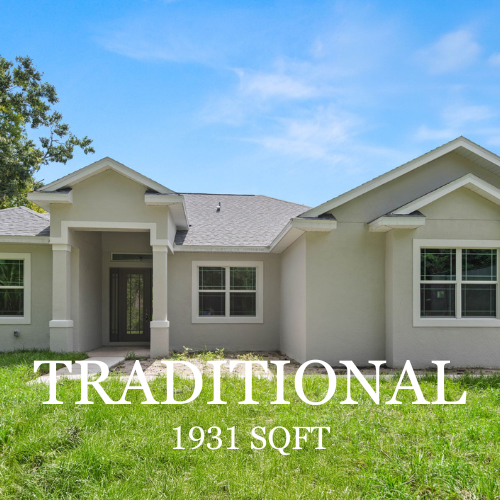 A beige, single-story traditional style house with a grey roof and front entryway, surrounded by a grassy yard.