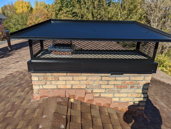 A chimney expert doing a home chimney inspection in Minnetonka, MN.