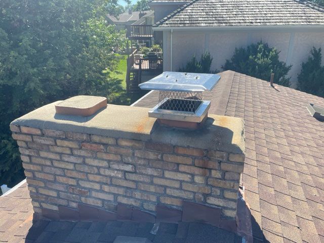 Professional team performing chimney cleaning in a home in Eagan, MN.
