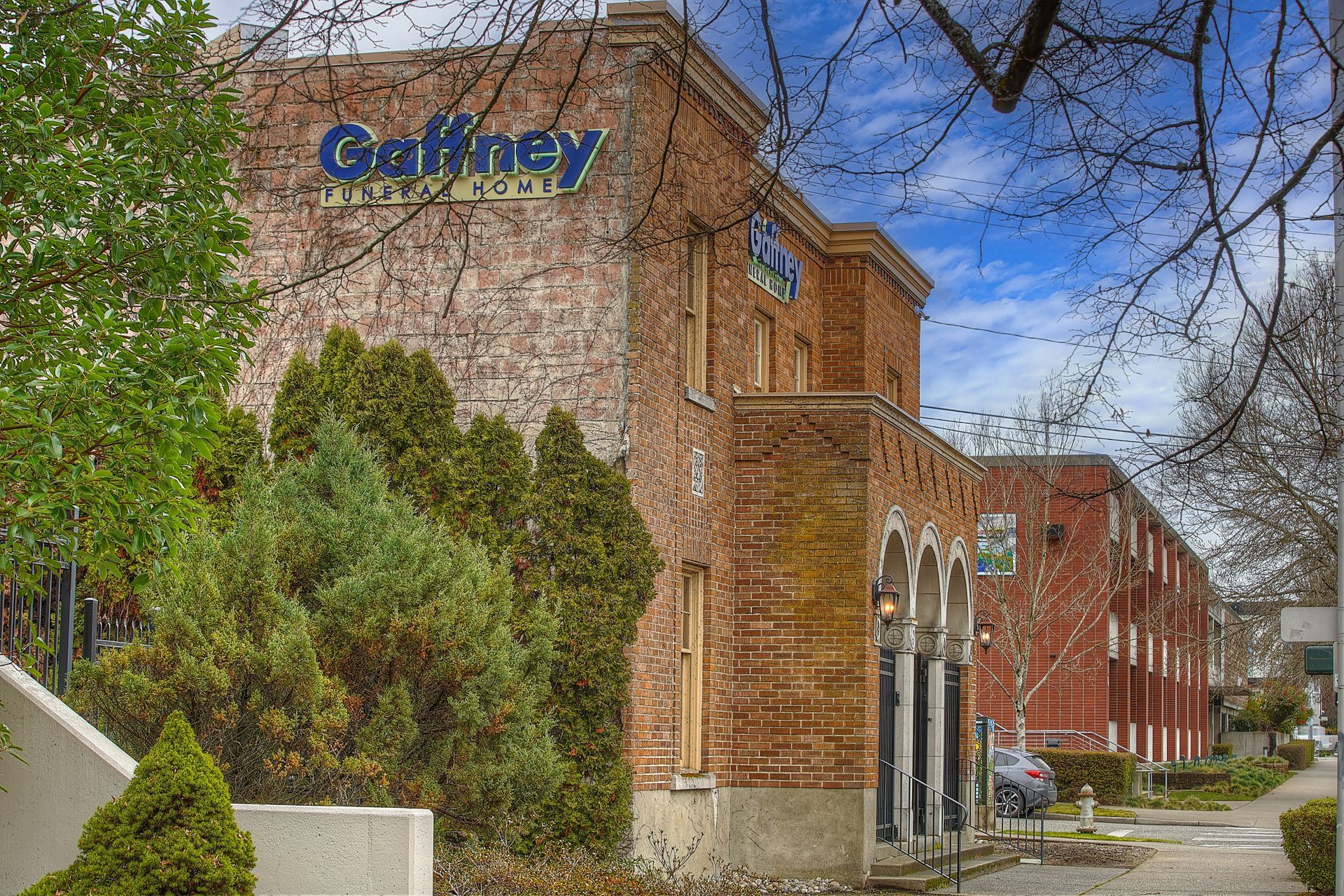 A brick building with ivy growing on the side of it