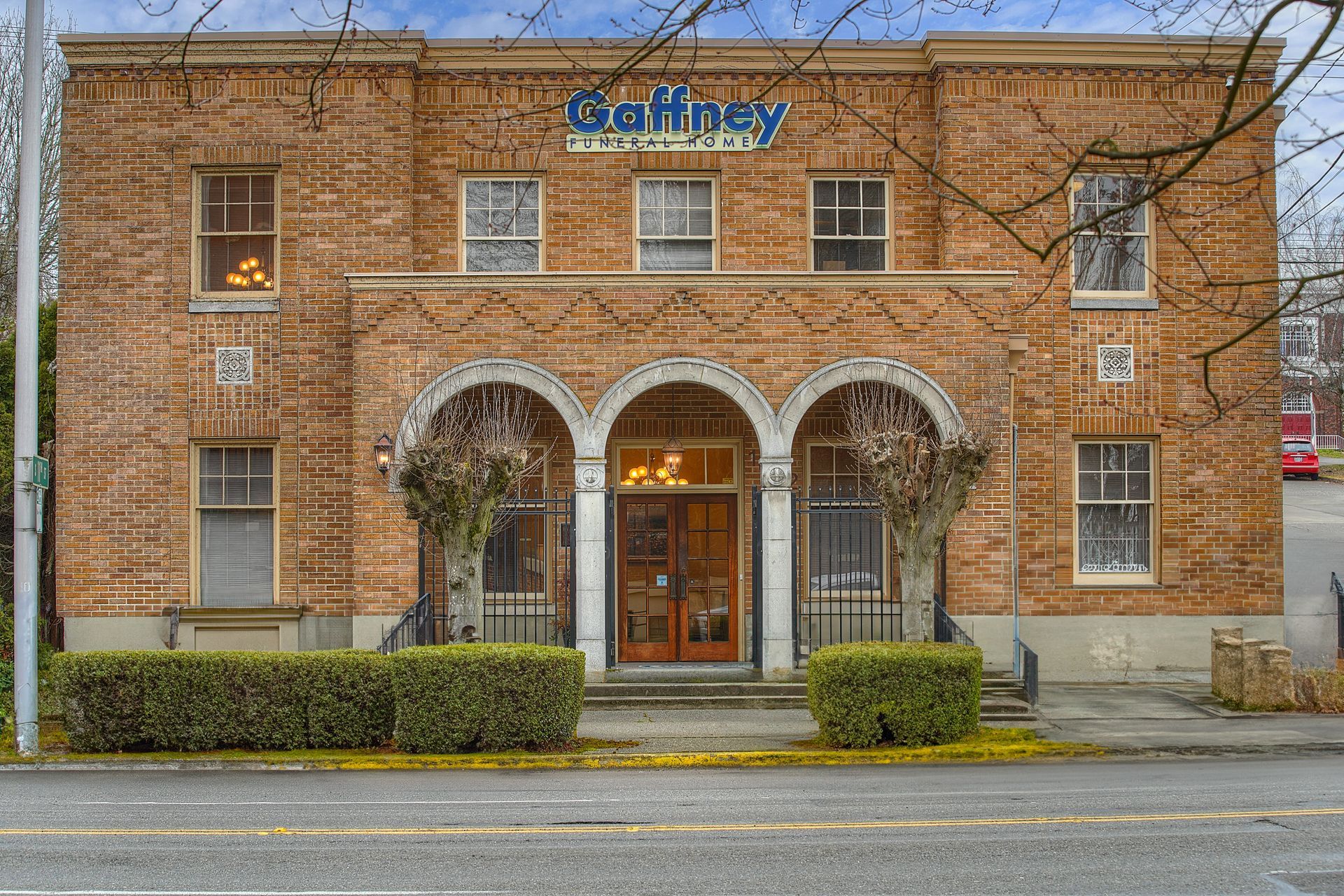 A large brick building with a sign in front of it.