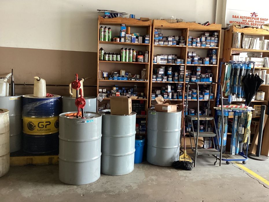 Barrels and shelves of hardware and supplies in a workshop.
