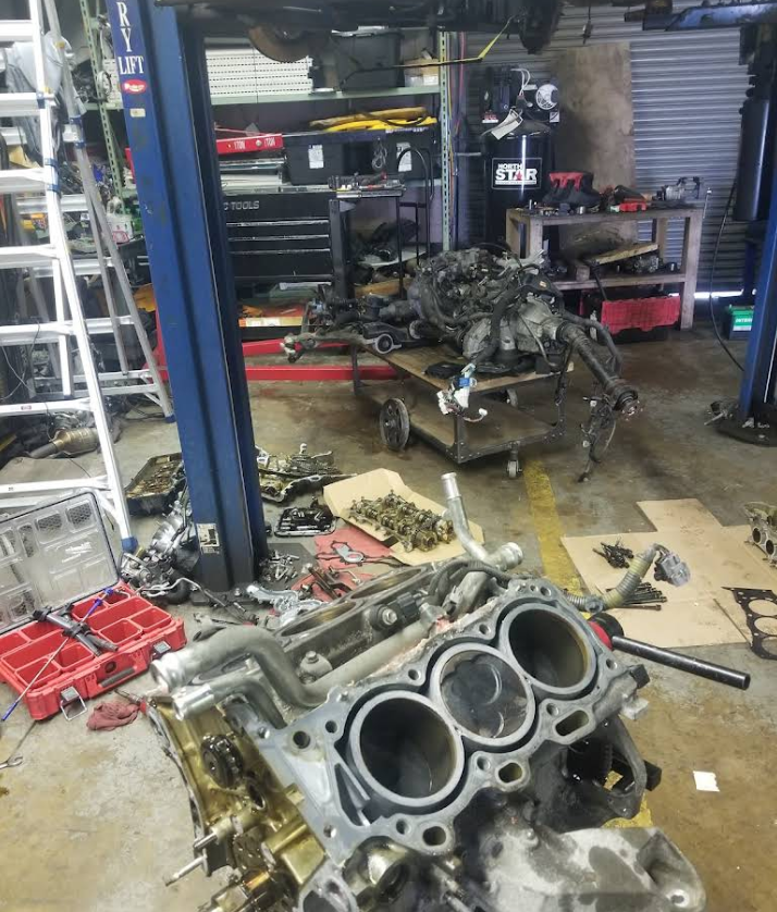 A car engine is being worked on in a garage