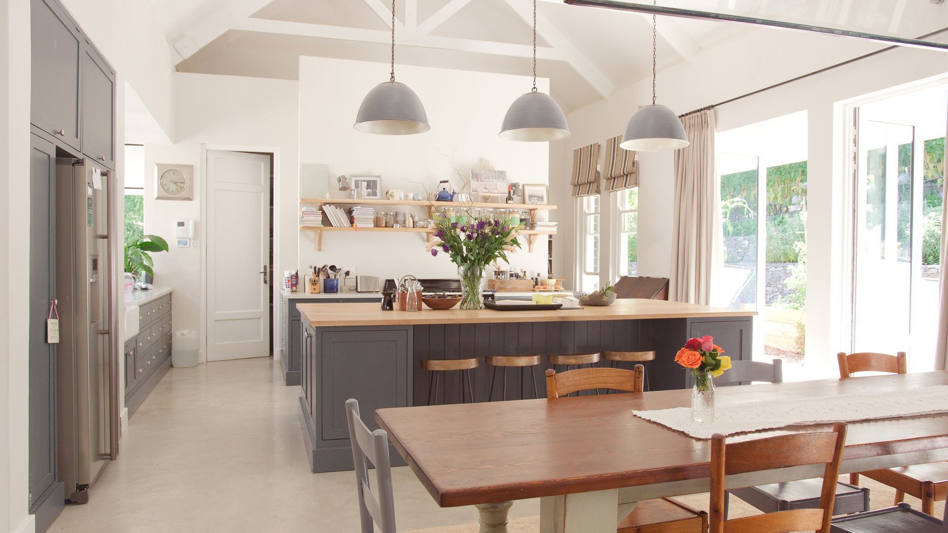 Renovated room with debris. White walls, tan floor. Construction tools and sawdust scattered.