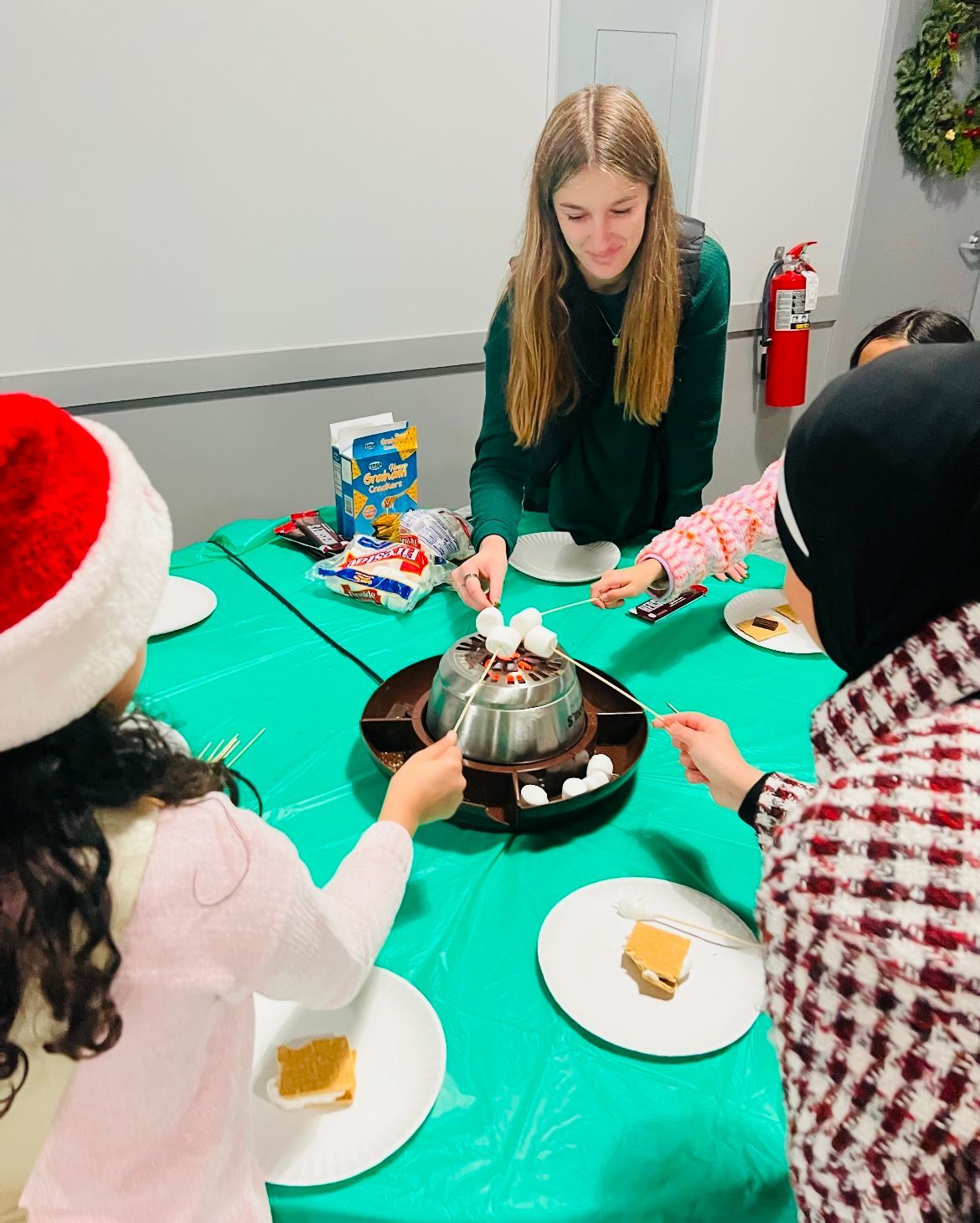 A group of people are sitting around a table eating food.