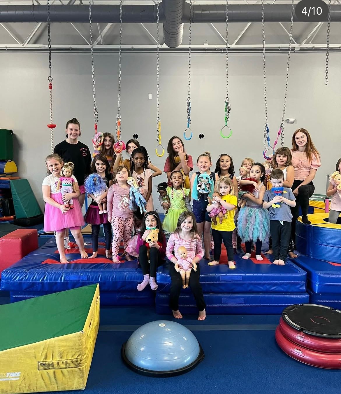 A group of children are posing for a picture in a gym.