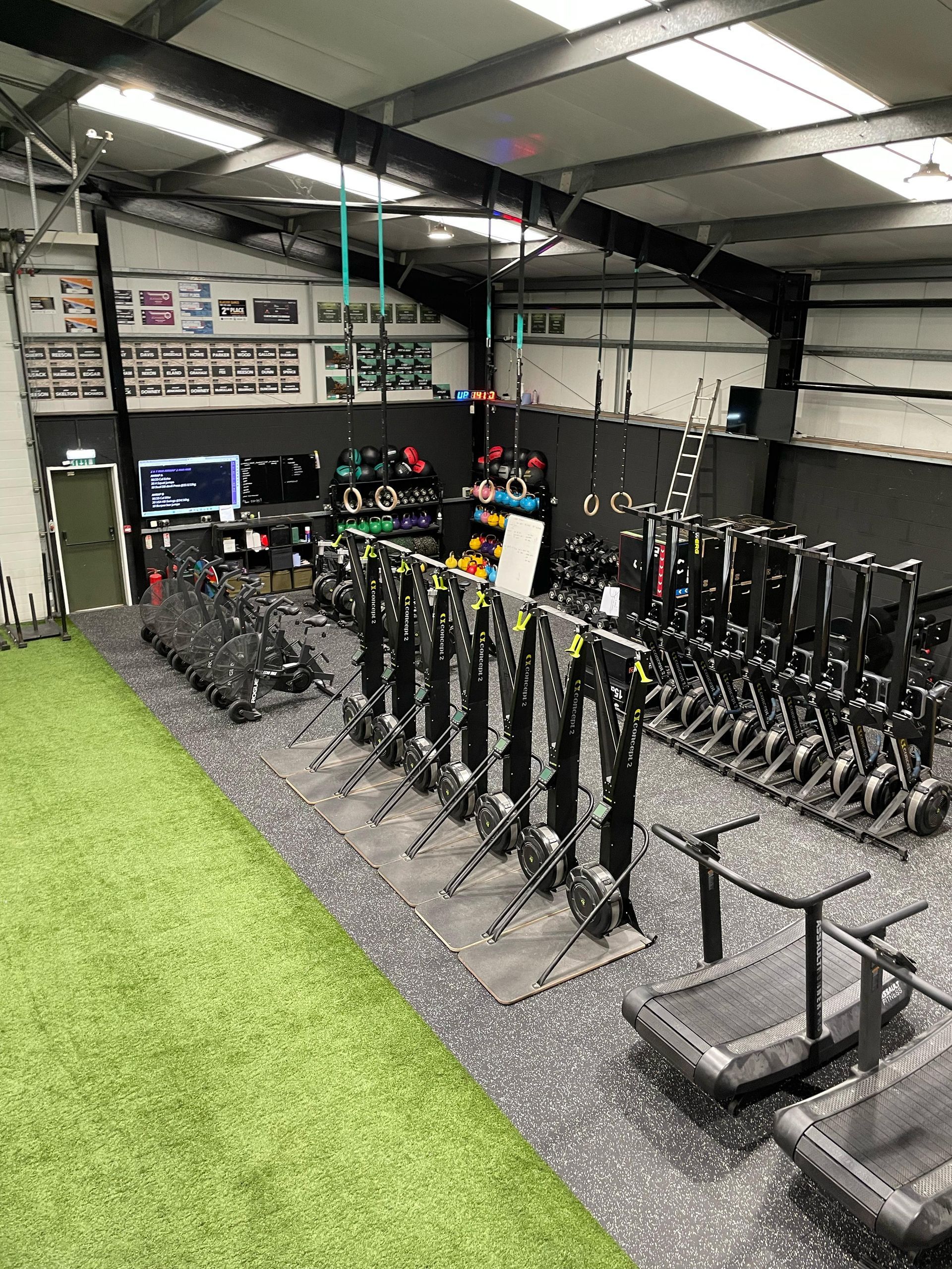 A large gym filled with lots of exercise equipment.