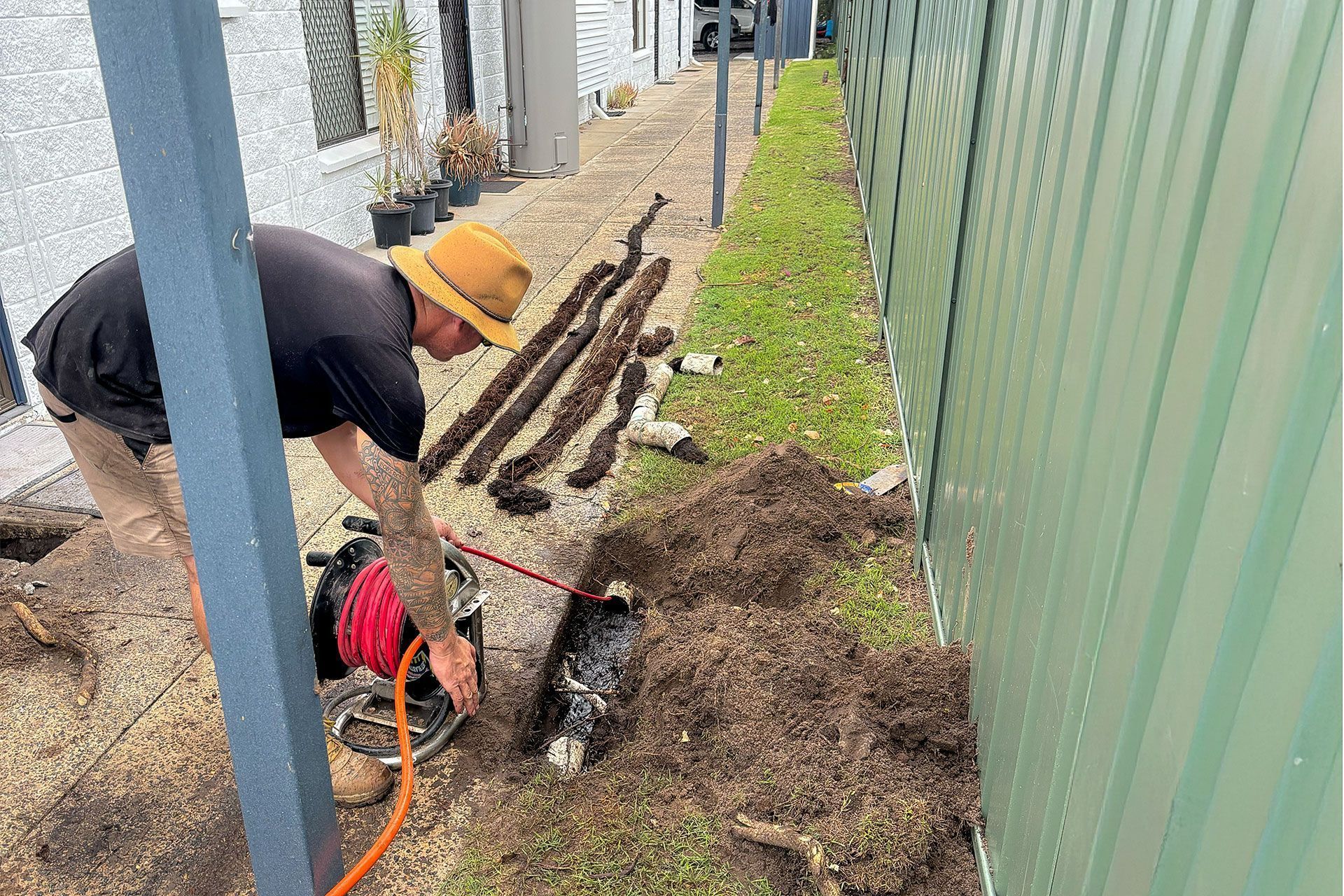 A Person Inspecting The Drains