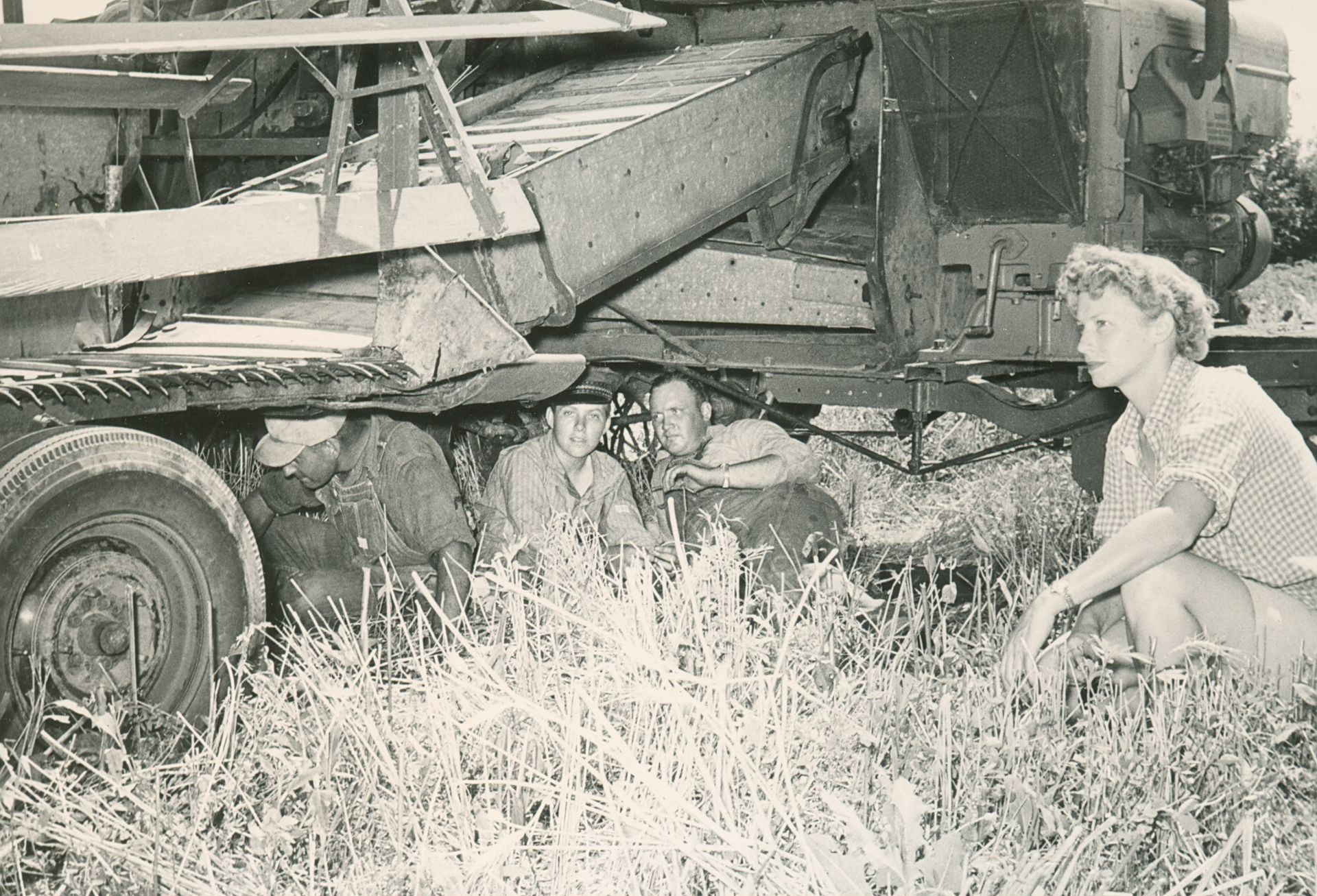 Anne Bingman checking a combine with famers, 1948. LandLogic Model Training for Medical Providers