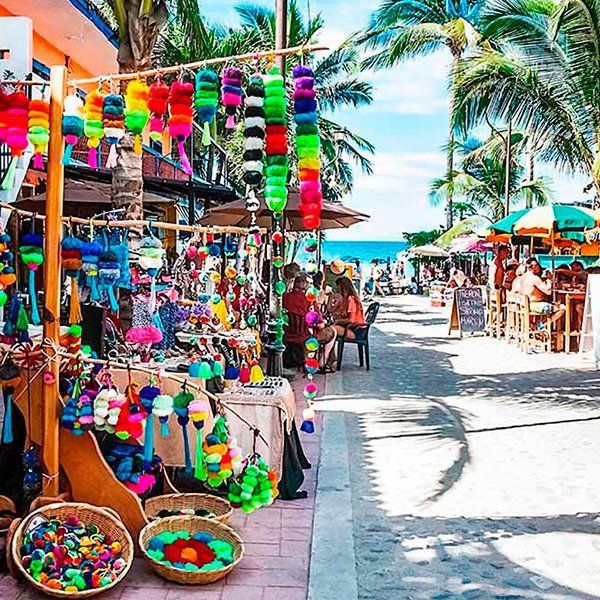 A street filled with lots of colorful lanterns and baskets.