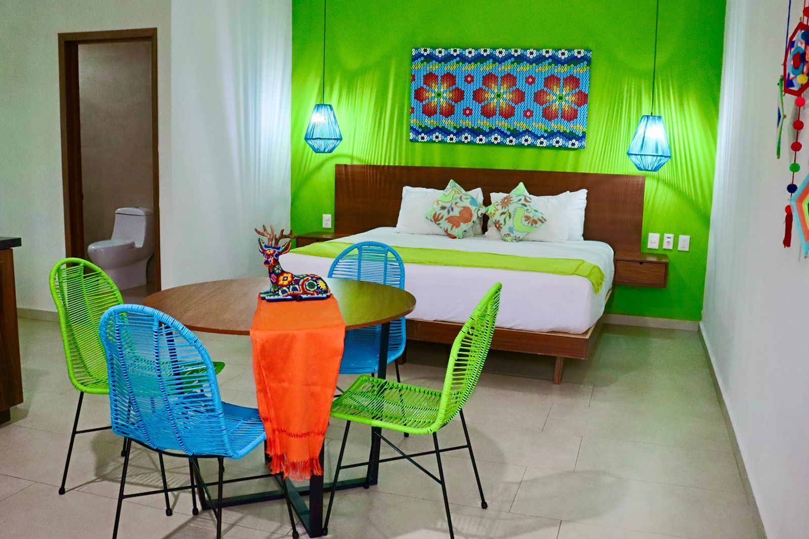 A hotel room with a bed , table and chairs.