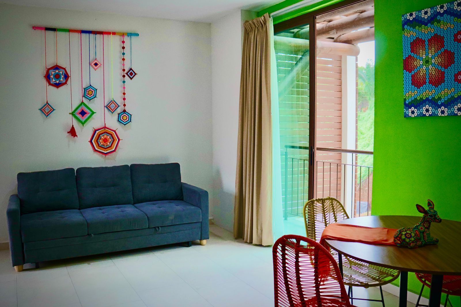 A living room with a couch , table and chairs.