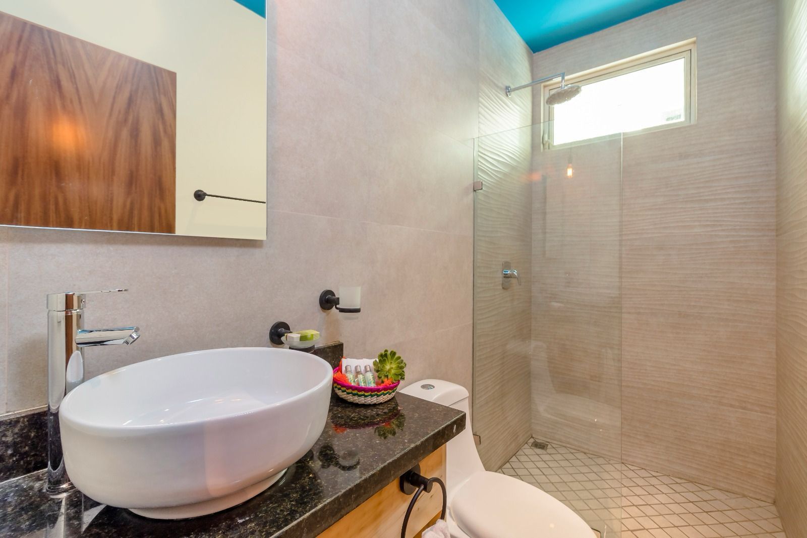 A bathroom with a sink , toilet and shower.