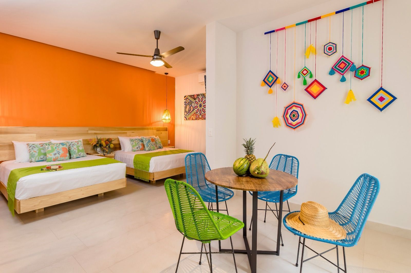 A hotel room with two beds , a table and chairs.