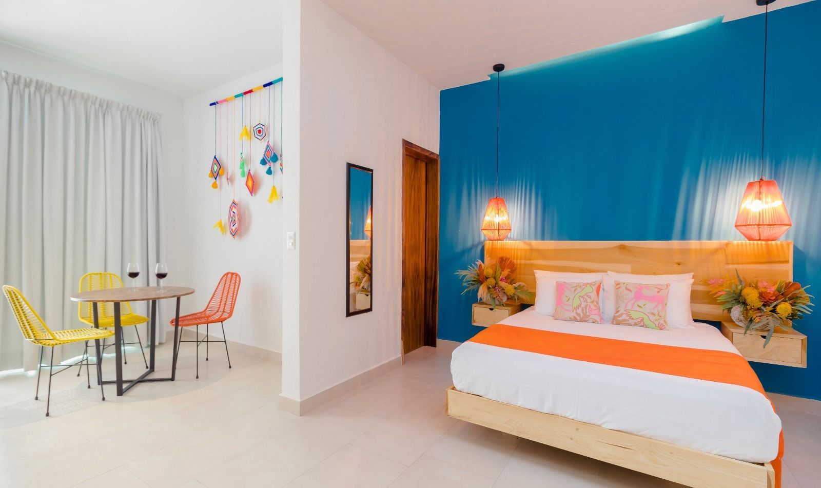 A bedroom with a king size bed , a table and chairs.