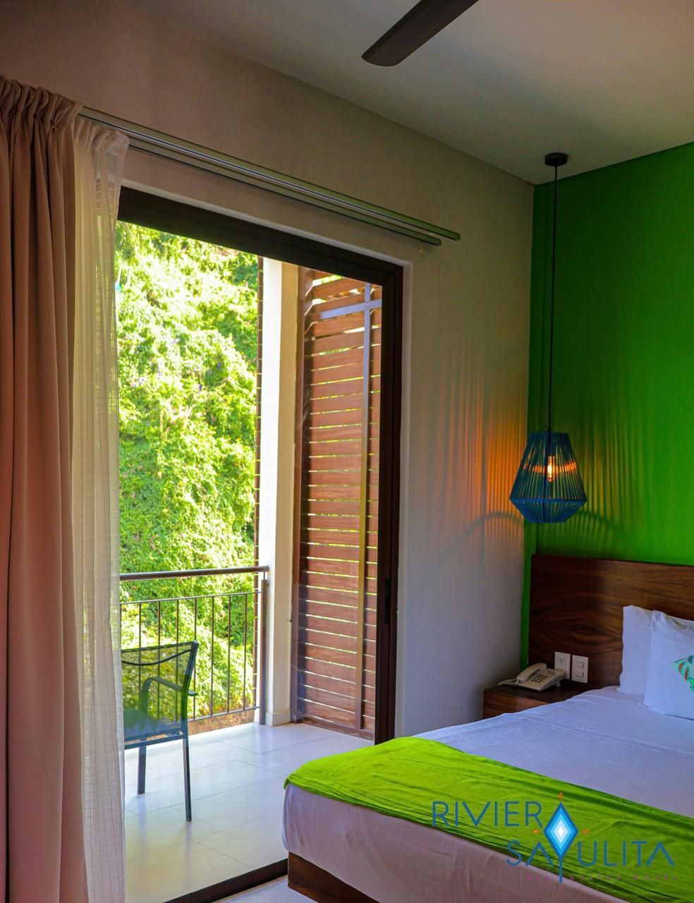 A hotel room with a bed and a balcony