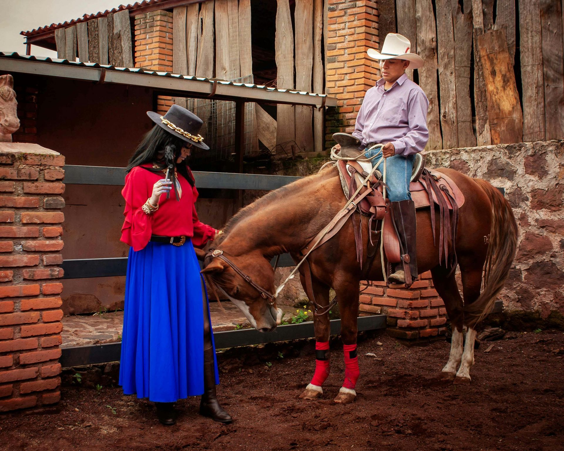 A man and a woman are standing next to a horse