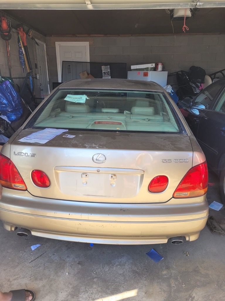 Gold Lexus GS 300 sedan parked in a garage.