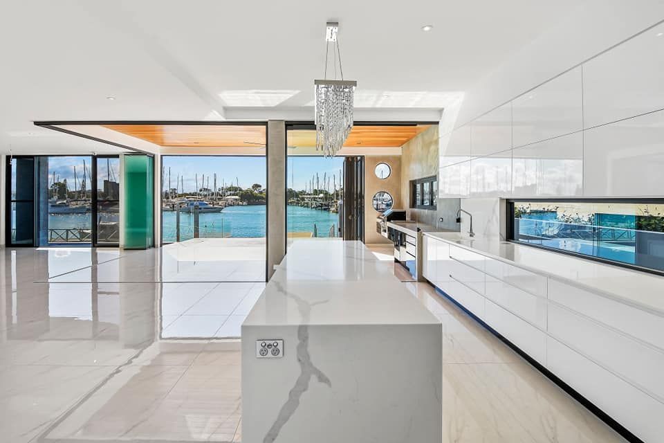 A kitchen with a large island and a view of the water — Simonetto'S Cabinets & Joinery in Nambour, QLD