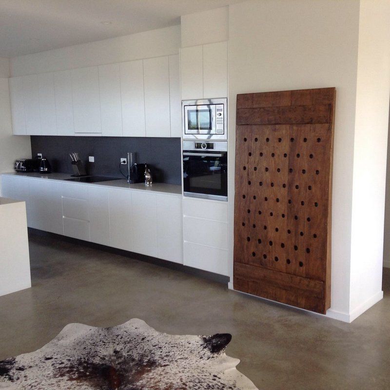 A Kitchen With Black Cabinets and a Round Window — Simonetto'S Cabinets & Joinery in Nambour, QLD