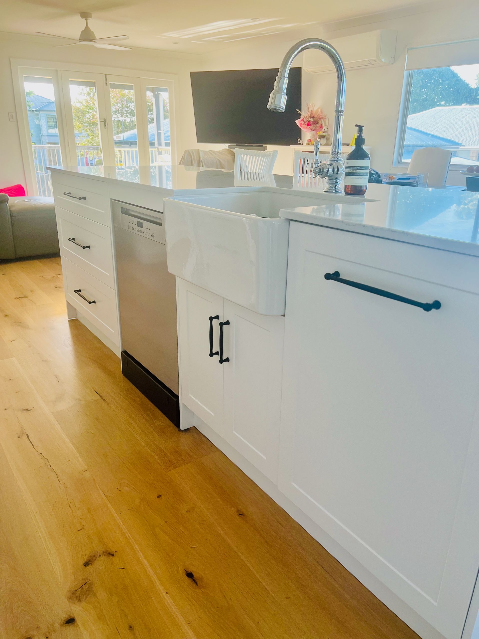 A Kitchen with A Large Island and Lots of Windows — Simonetto'S Cabinets & Joinery in Nambour, QLD