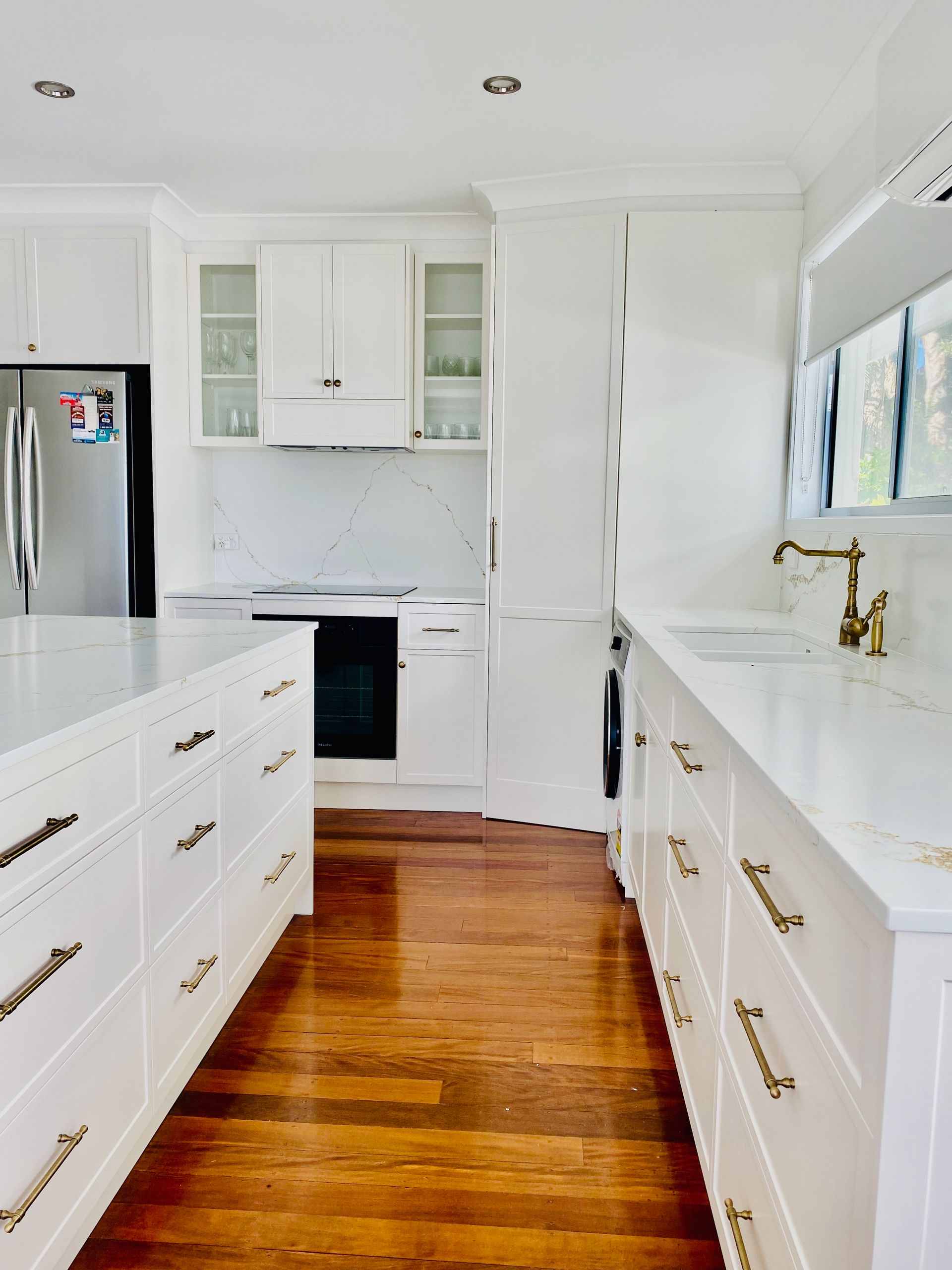 A Kitchen with White Cabinets and Wooden Cabinets and A Stove — Simonetto'S Cabinets & Joinery in Nambour, QLD