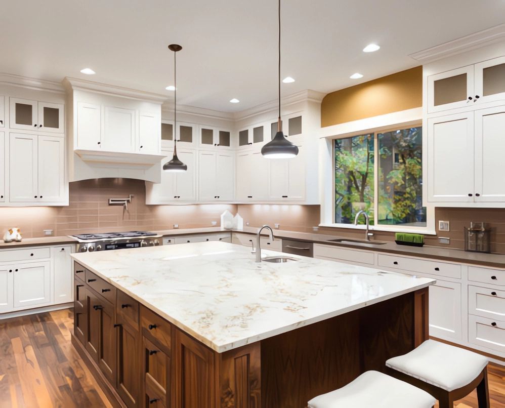 A Kitchen With White Cabinets And A Large Island In The Middle — Simonetto'S Cabinets & Joinery in Nambour, QLD